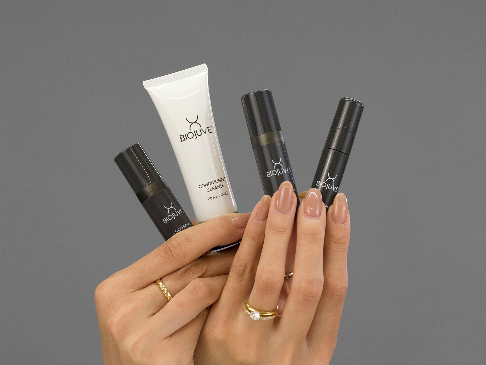 Closeup of Laziza from LAZ Skincare holding the products included in the BioJuve Travel Kit in her hands