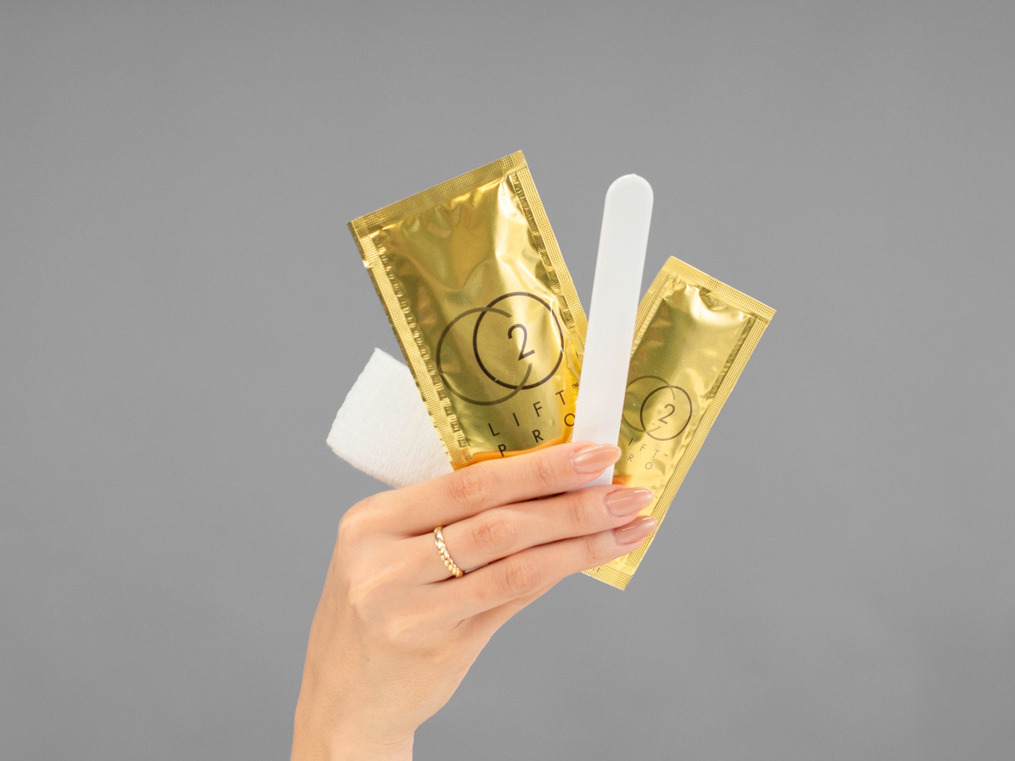 Closeup of Laziza from LAZ Skincare showing contents included in the CO2Lift Pro Carboxy Gel Mask in her hand