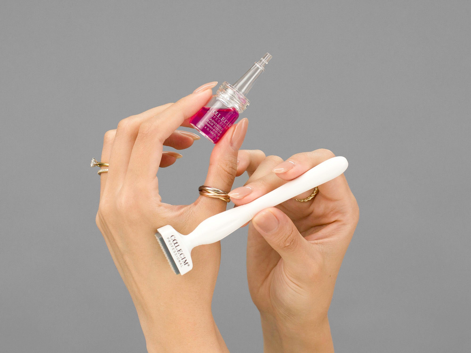 Closeup of Laziza from LAZ Skincare holding the solution bottle and dermastamp Calecim Advanced Hair System in her hands