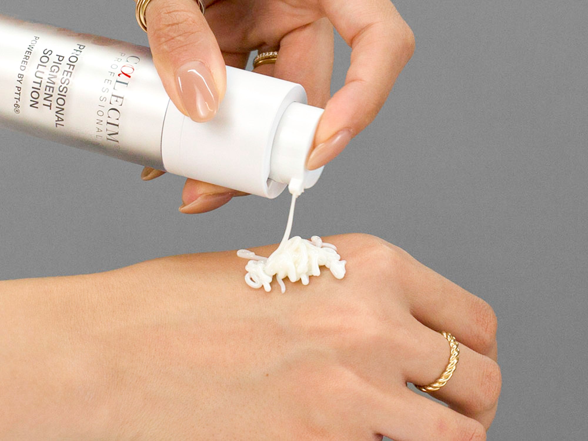 Closeup of Laziza from LAZ Skincare applying Calecim Professional Pigment Solution to her hand