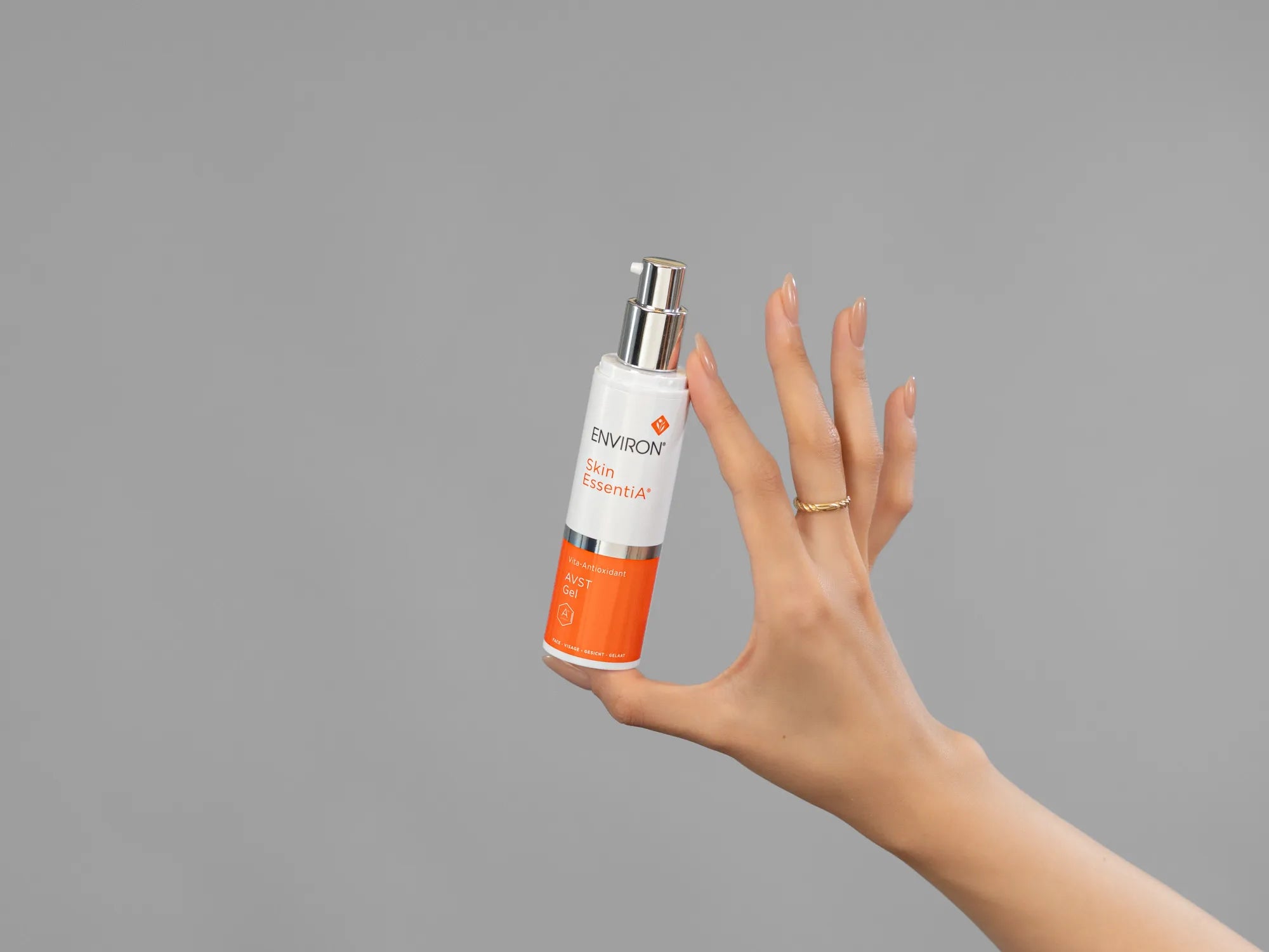 Closeup of Laziza from LAZ Skincare holding up a bottle of Environ AVST Gel