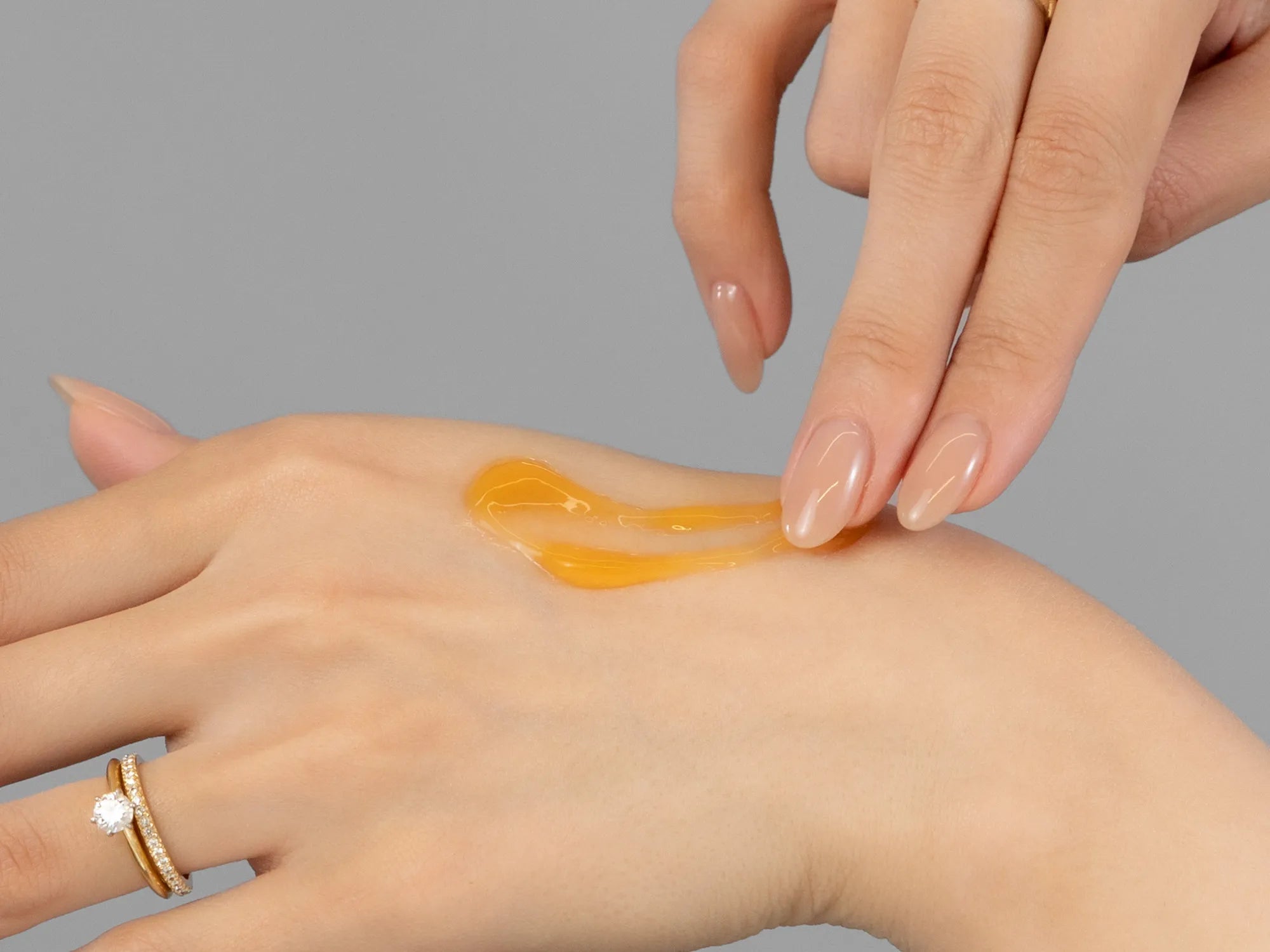 Laziza from LAZ Skincare demonstrating the texture and application of Environ AVST Gel on her hand