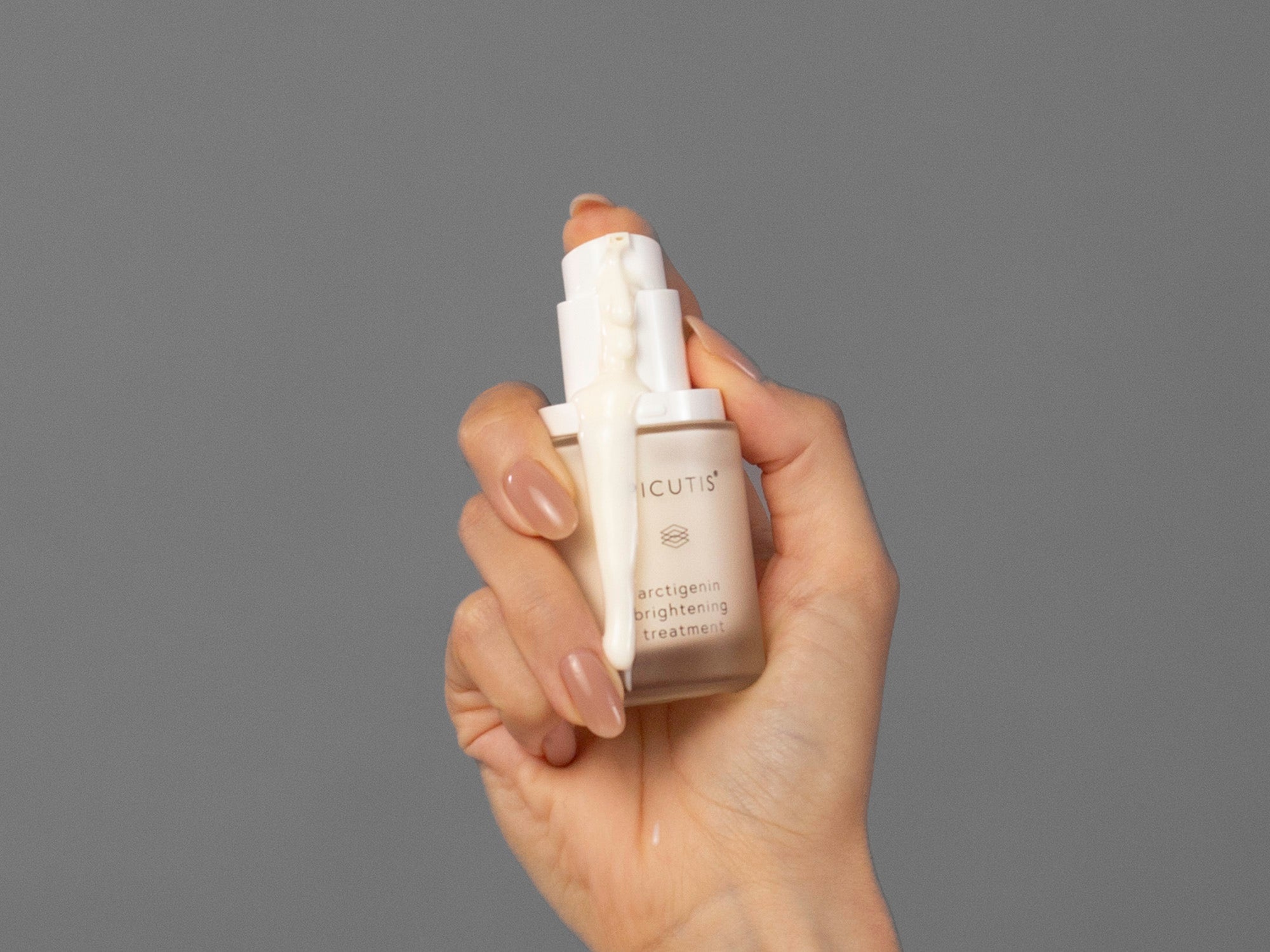 Closeup of Laziza from LAZ Skincare demonstrating the pump from a bottle of Epicutis Arctigenin Brightening Treatment