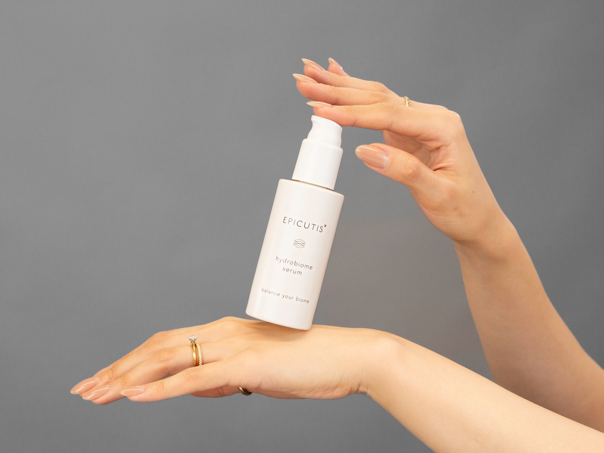 Closeup of Laziza from LAZ Skincare holding a bottle of Epicutis Hydrobiome Serum in her hands