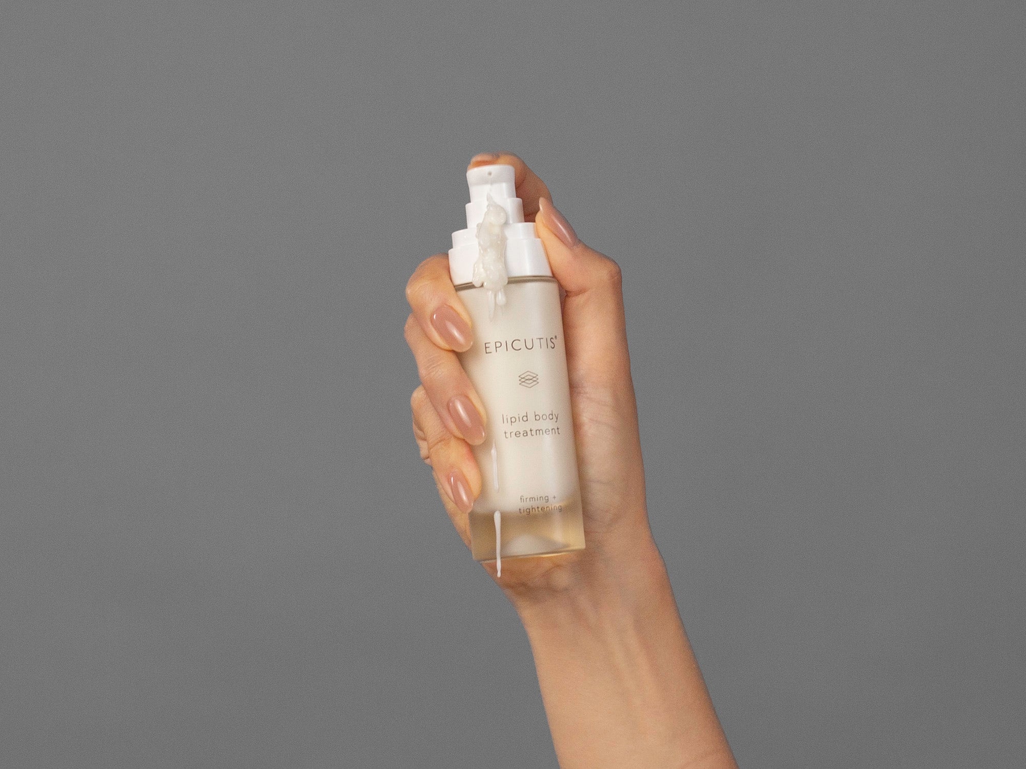 Closeup of Laziza from LAZ Skincare demonstrating the pump for Epicutis Lipid Body Treatment in her hand