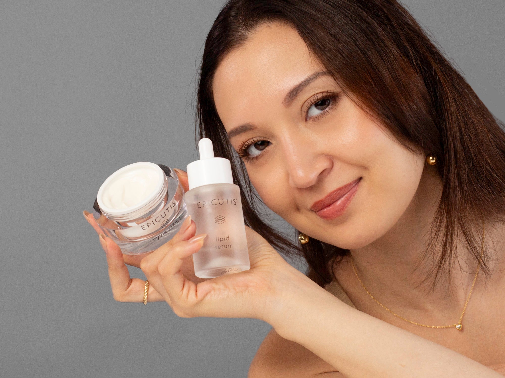 Laziza from LAZ Skincare holding Hyvia Cream and Lipid Serum included in Epicutis Luxury Skincare Set