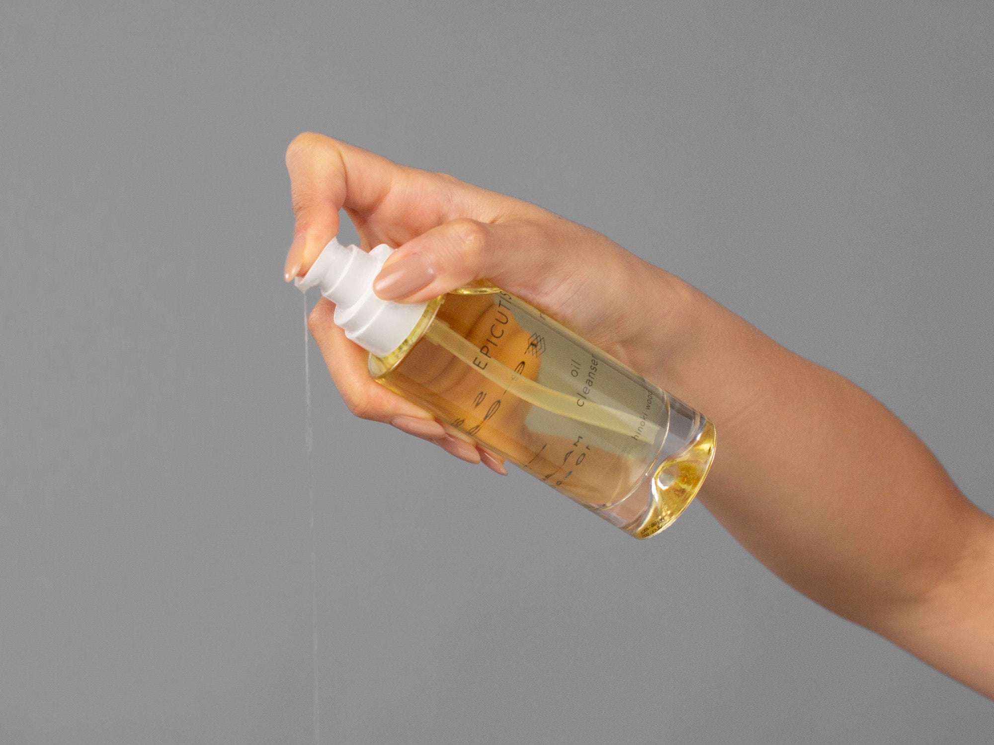 Closeup of Laziza from LAZ Skincare holding a bottle of Epicutis Oil Cleanser in her hand