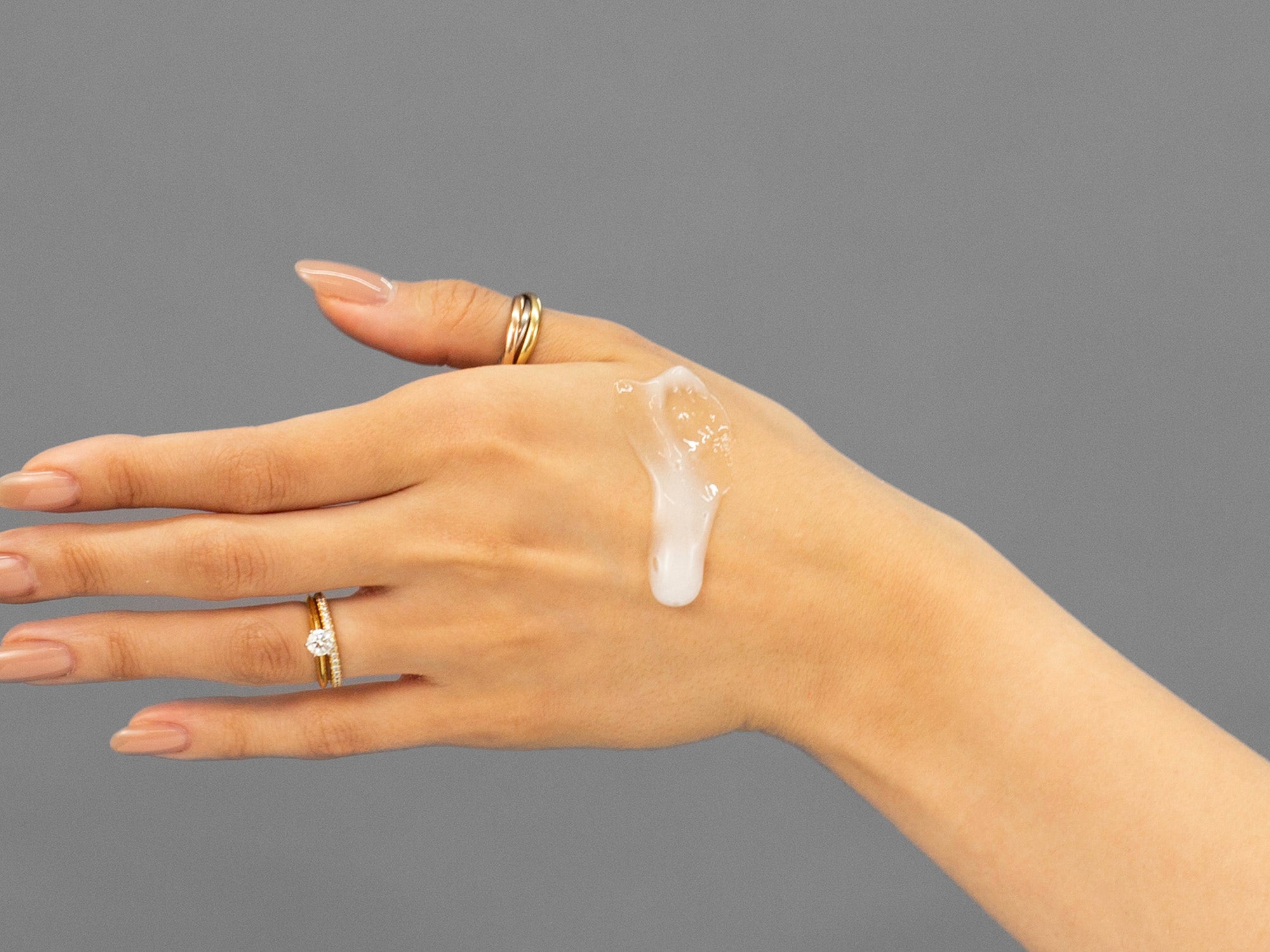 Closeup of Laziza from LAZ Skincare applying Face Reality Acne Face & Body Wash to her hand