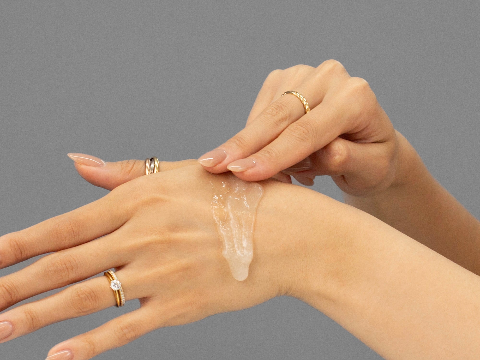 Closeup of Laziza from LAZ Skincare applying Face Reality Antioxidant Scrub to her hand