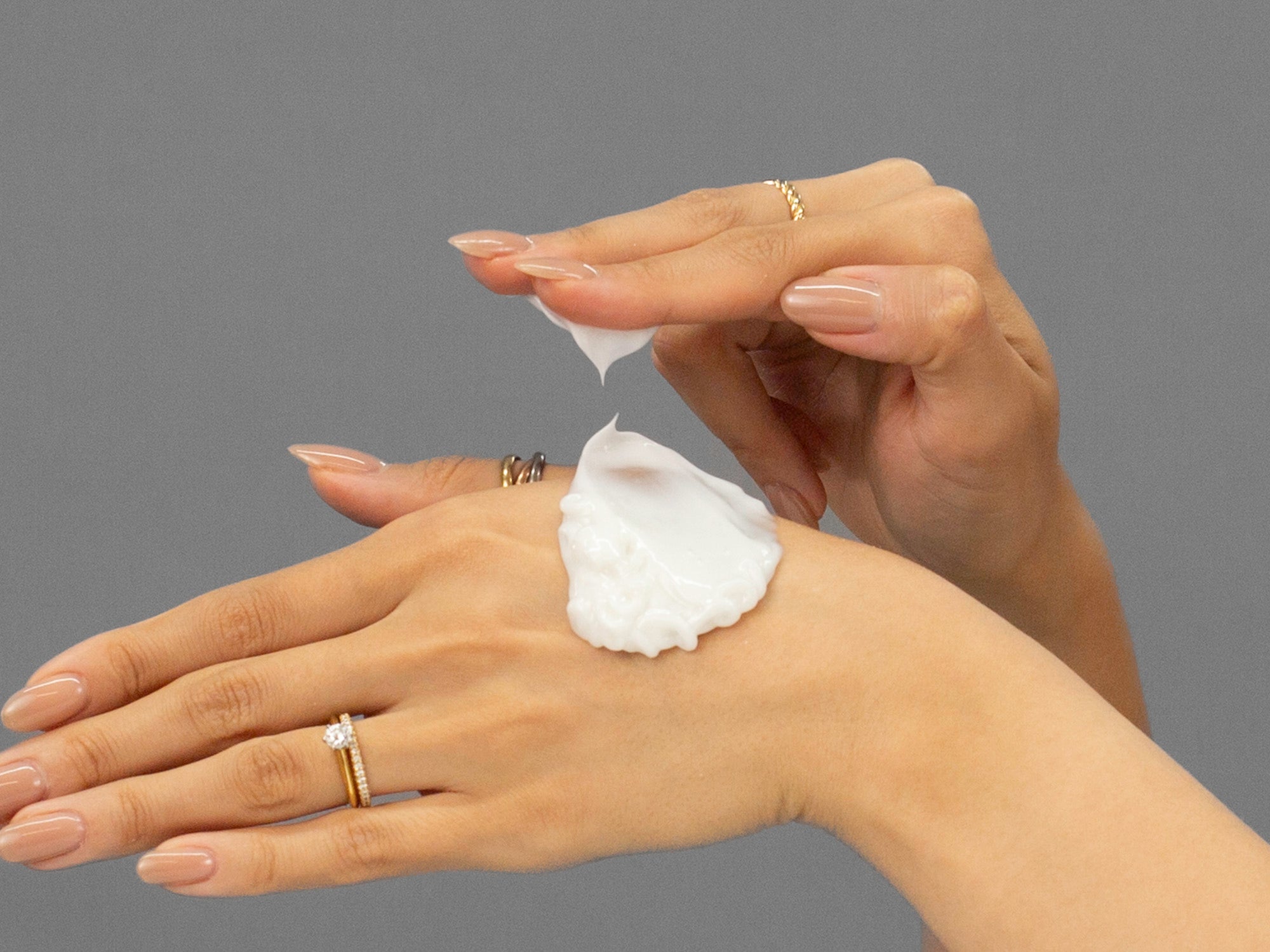 Closeup of Laziza from LAZ Skincare applying Face Reality Barrier Balance Creamy Cleanser to her hand