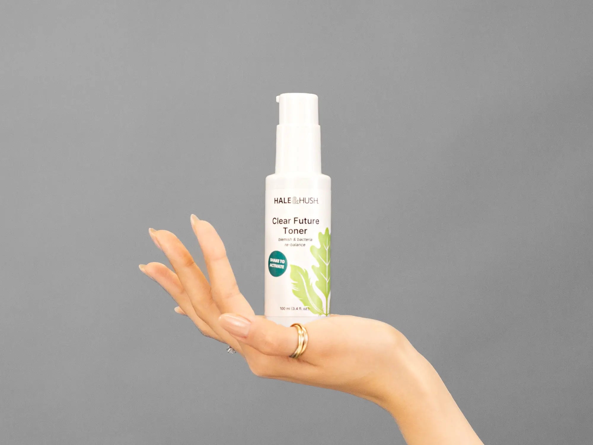 Closeup of Laziza from LAZ Skincare holding up a bottle of Hale & Hush Clear Future Toner