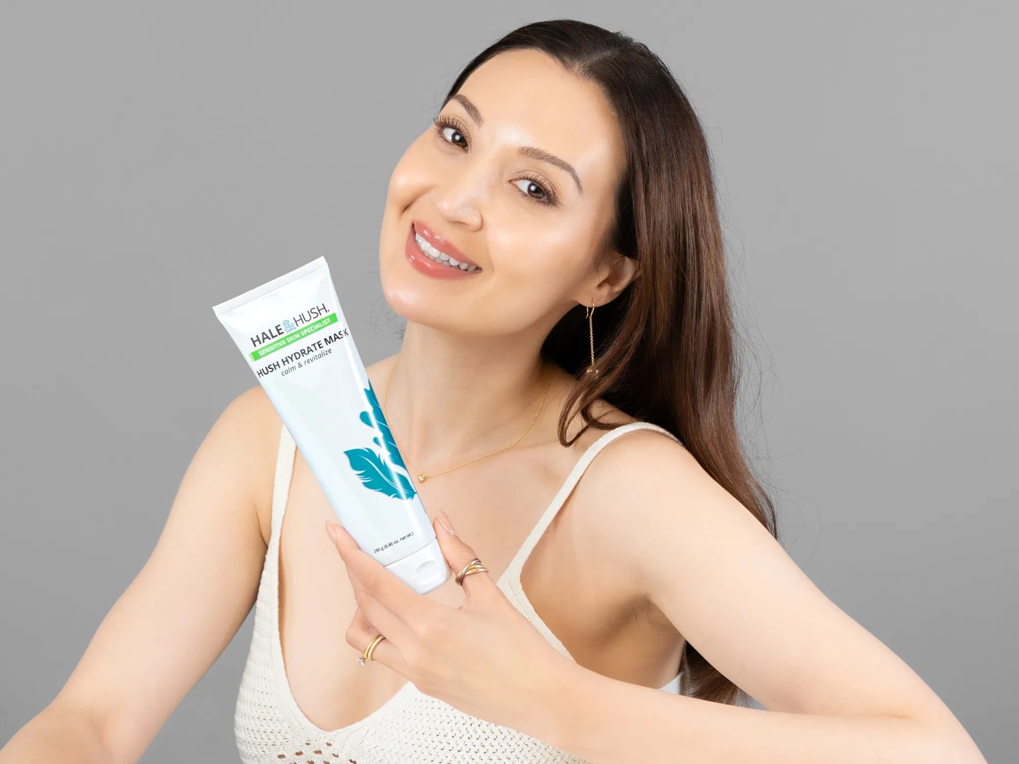 Laziza from LAZ Skincare holding a bottle of Hale & Hush Hush Hydrate Mask up to her face