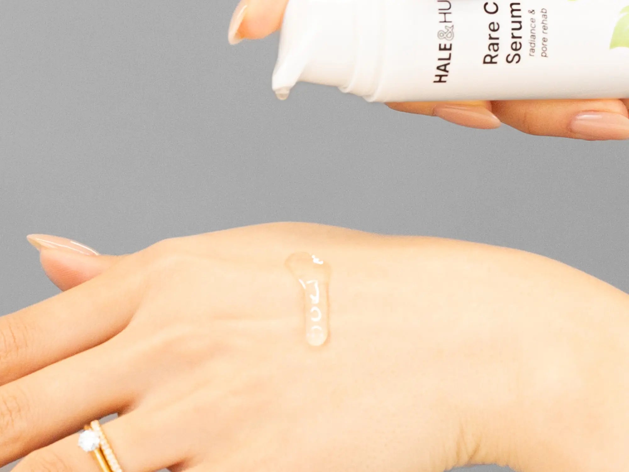 Laziza from LAZ Skincare demonstrating the texture and application of Hale & Hush Rare C Serum on her hand