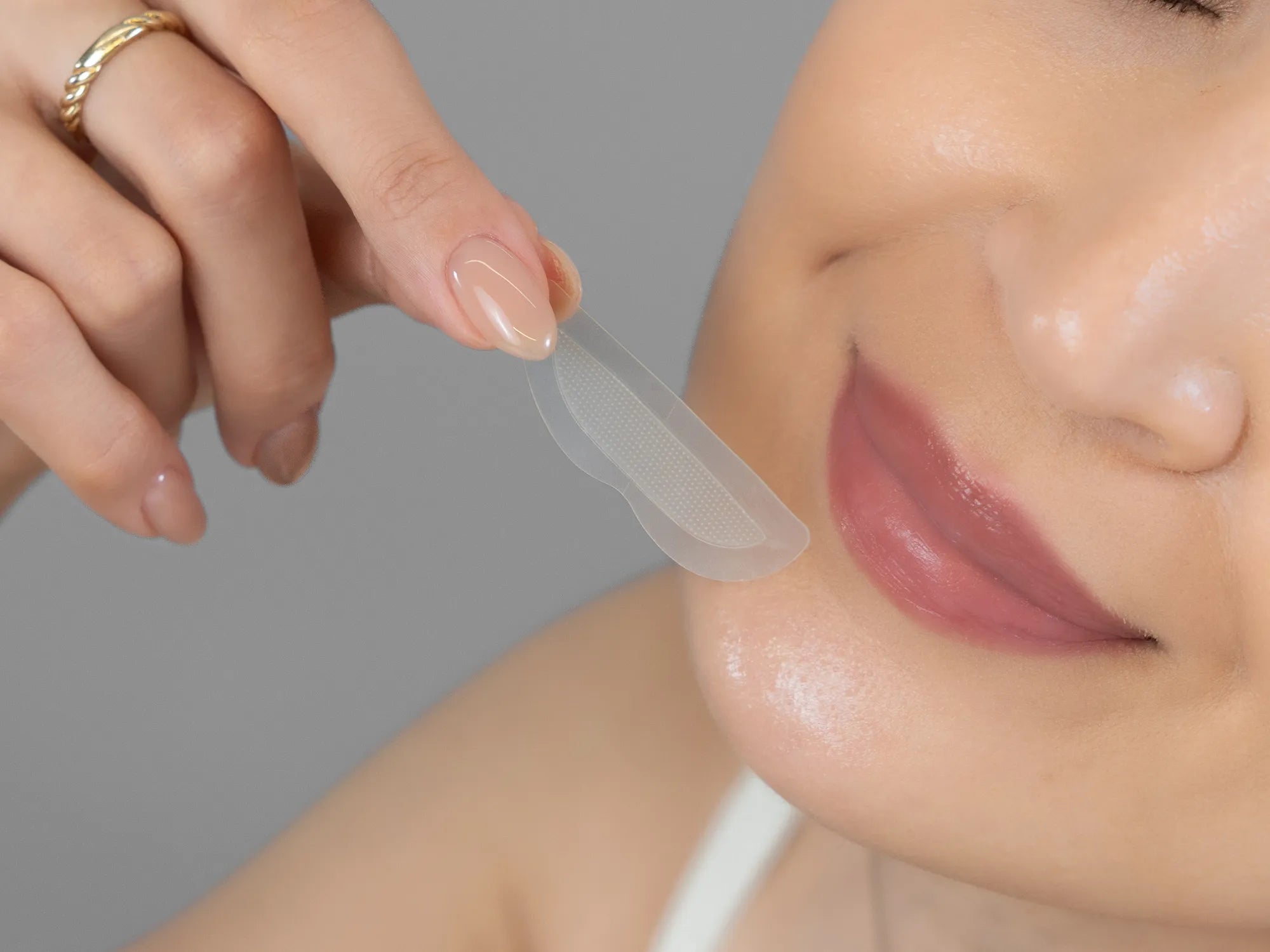 Laziza from LAZ Skincare demonstrating the texture and application of KrX Aesthetics Lip Darts on her hand