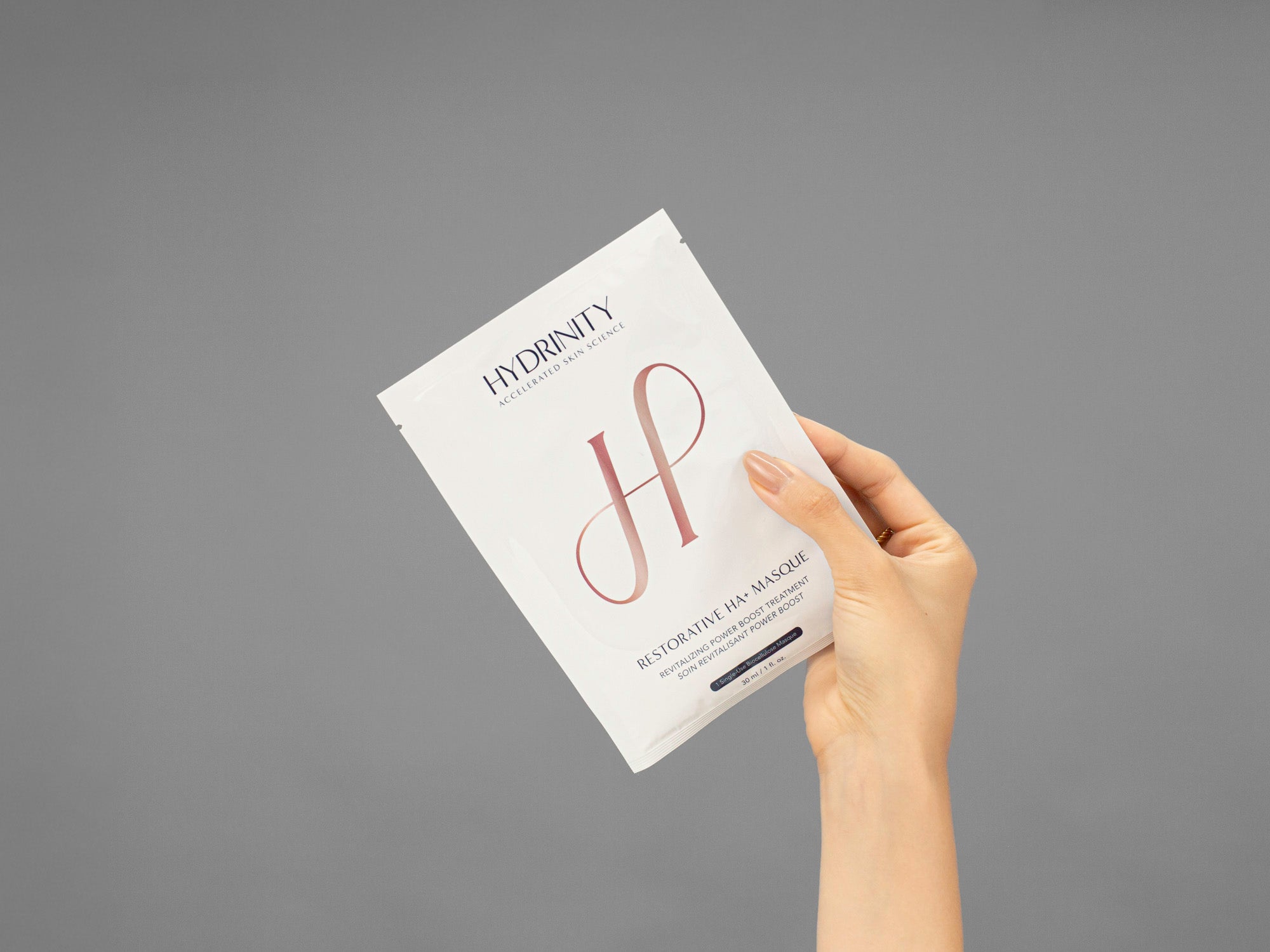 Closeup of Laziza from LAZ Skincare holding a sealed Hydrinity Restorative HA Mask