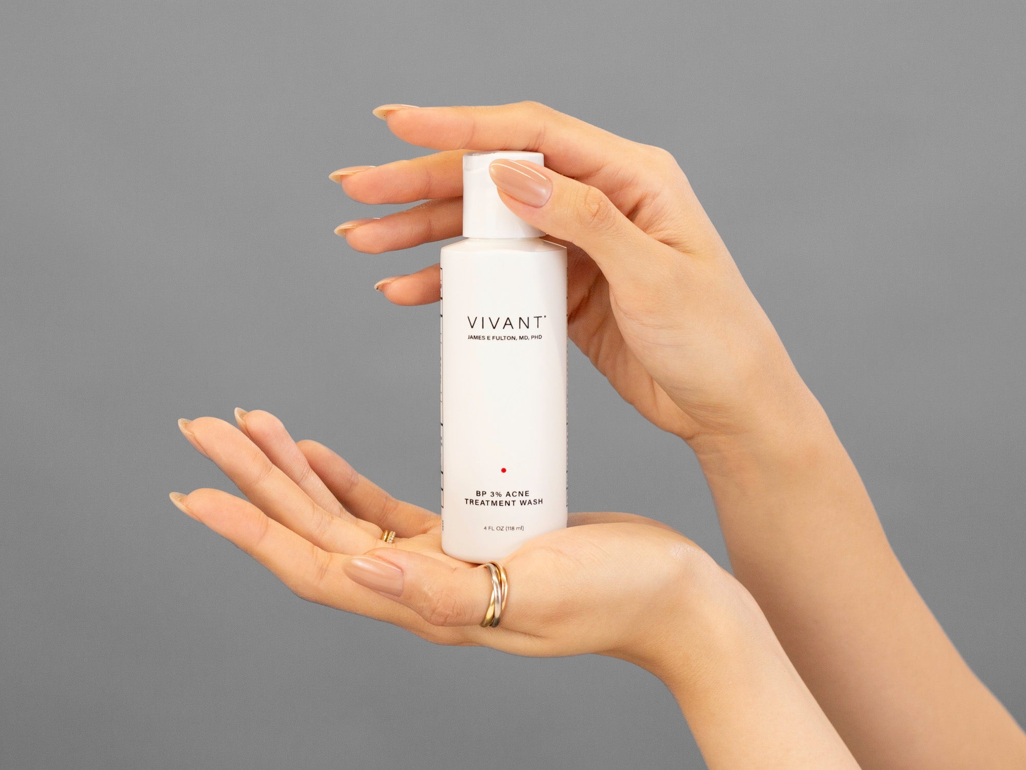 Closeup of Laziza from LAZ Skincare holding a bottle of Vivant BP 3% Acne Wash between her hands