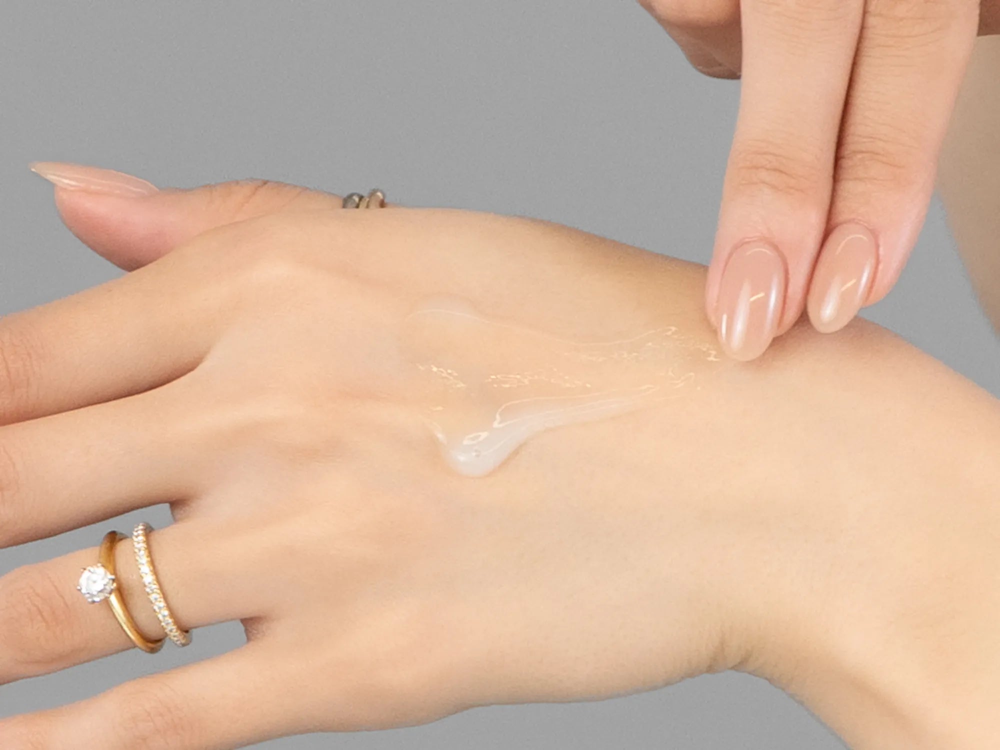 Laziza from LAZ Skincare demonstrating the texture and application of Young Goose Youth Reset on her hand
