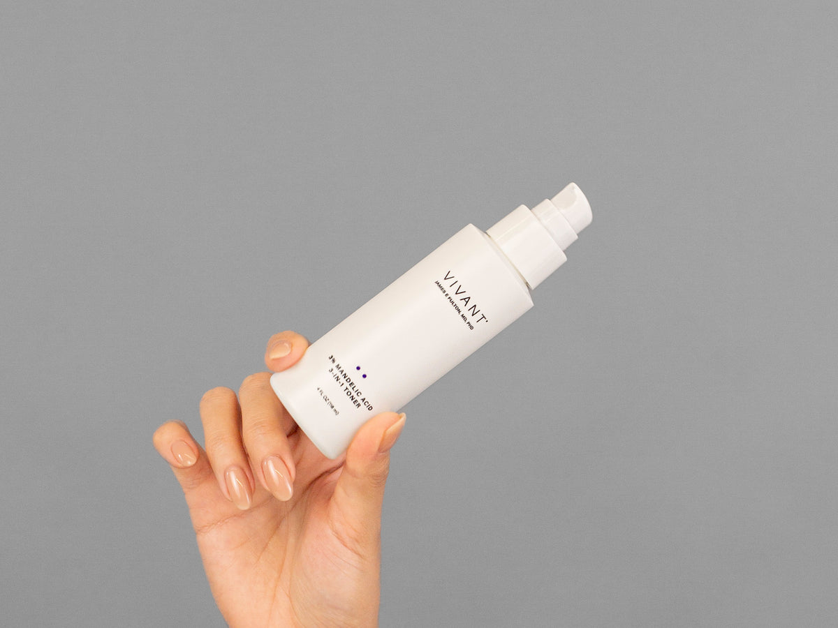 Closeup of Laziza from LAZ Skincare holding up a bottle of Vivant 3% Mandelic Acid 3-in-1 Toner