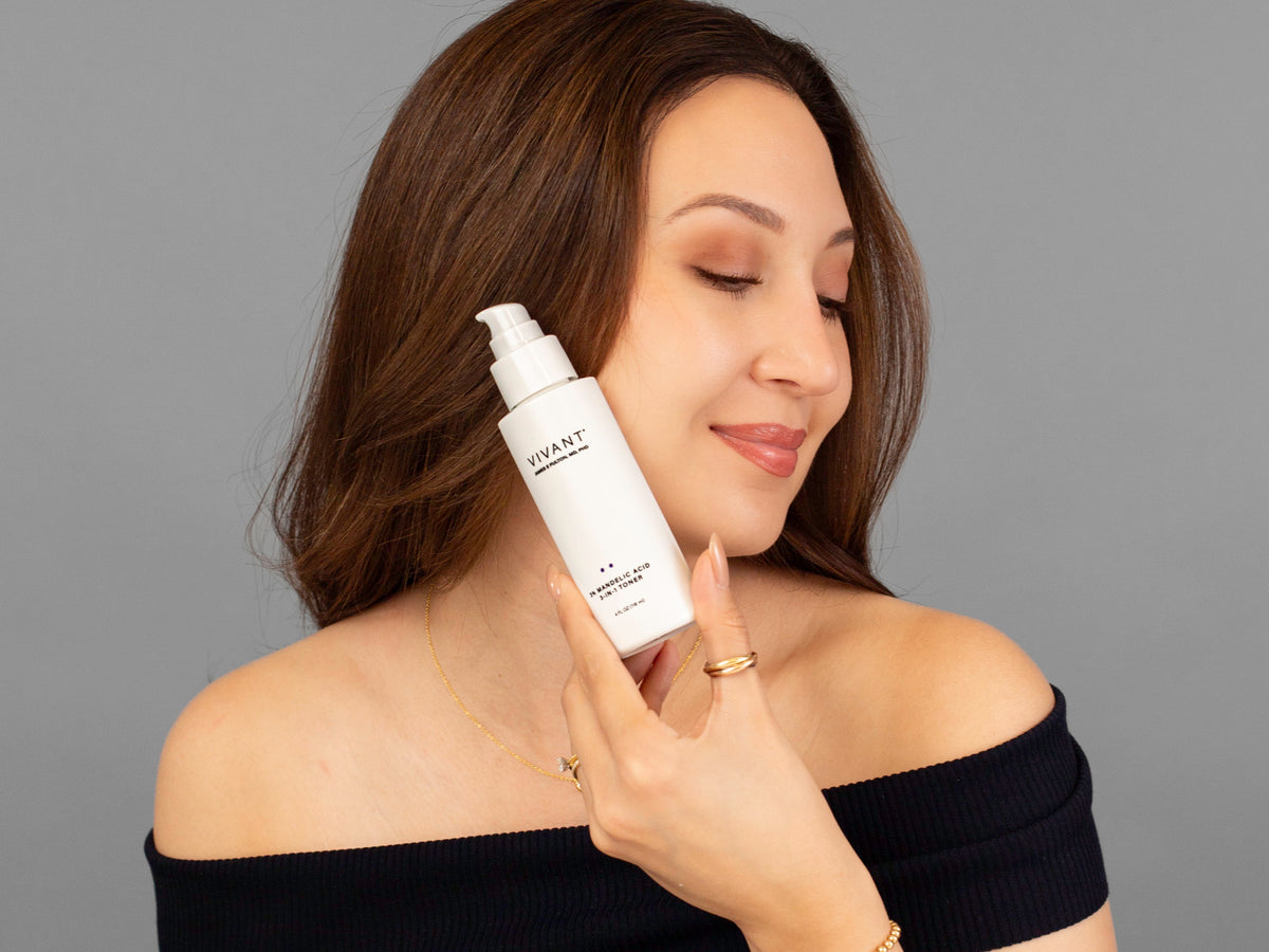 Laziza from LAZ Skincare holding a bottle of Vivant 3% Mandelic Acid 3-in-1 Toner up to her face