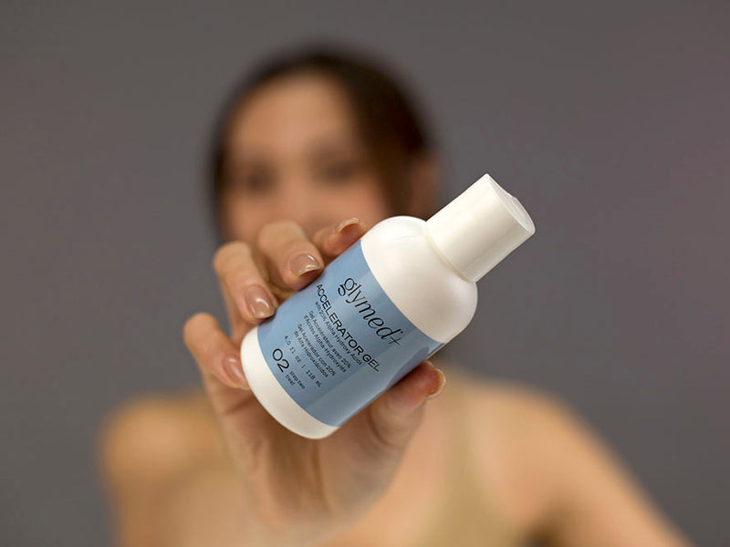 Laziza from LAZ Skincare demonstrating the texture and application of GlyMed Accelerator Gel on her hand