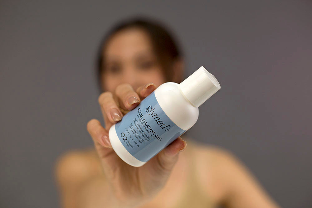Laziza from LAZ Skincare demonstrating the texture and application of GlyMed Accelerator Gel on her hand