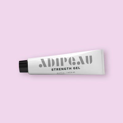 Tube of Adipeau Strength Gel on a light pink background