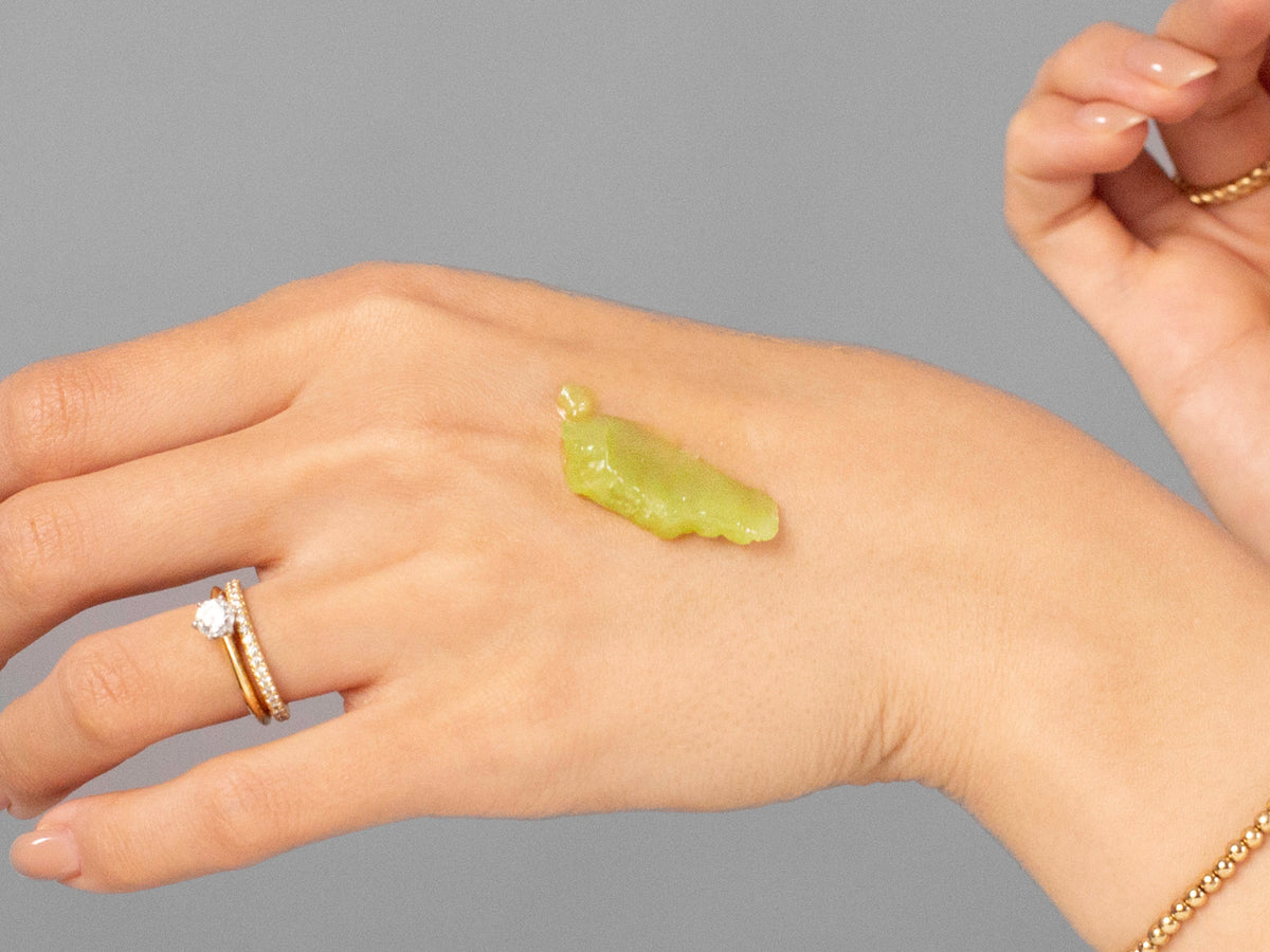 Laziza from LAZ Skincare demonstrating the texture and application of Anfisa ÂN-BALM on her hand