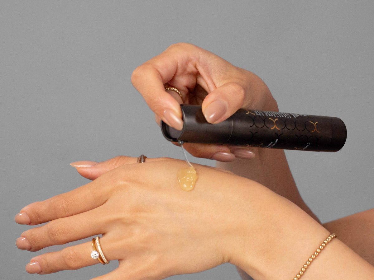 Laziza from LAZ Skincare demonstrating the texture and application of Biojuve Living Biome Essentials Serum Duo on her hand