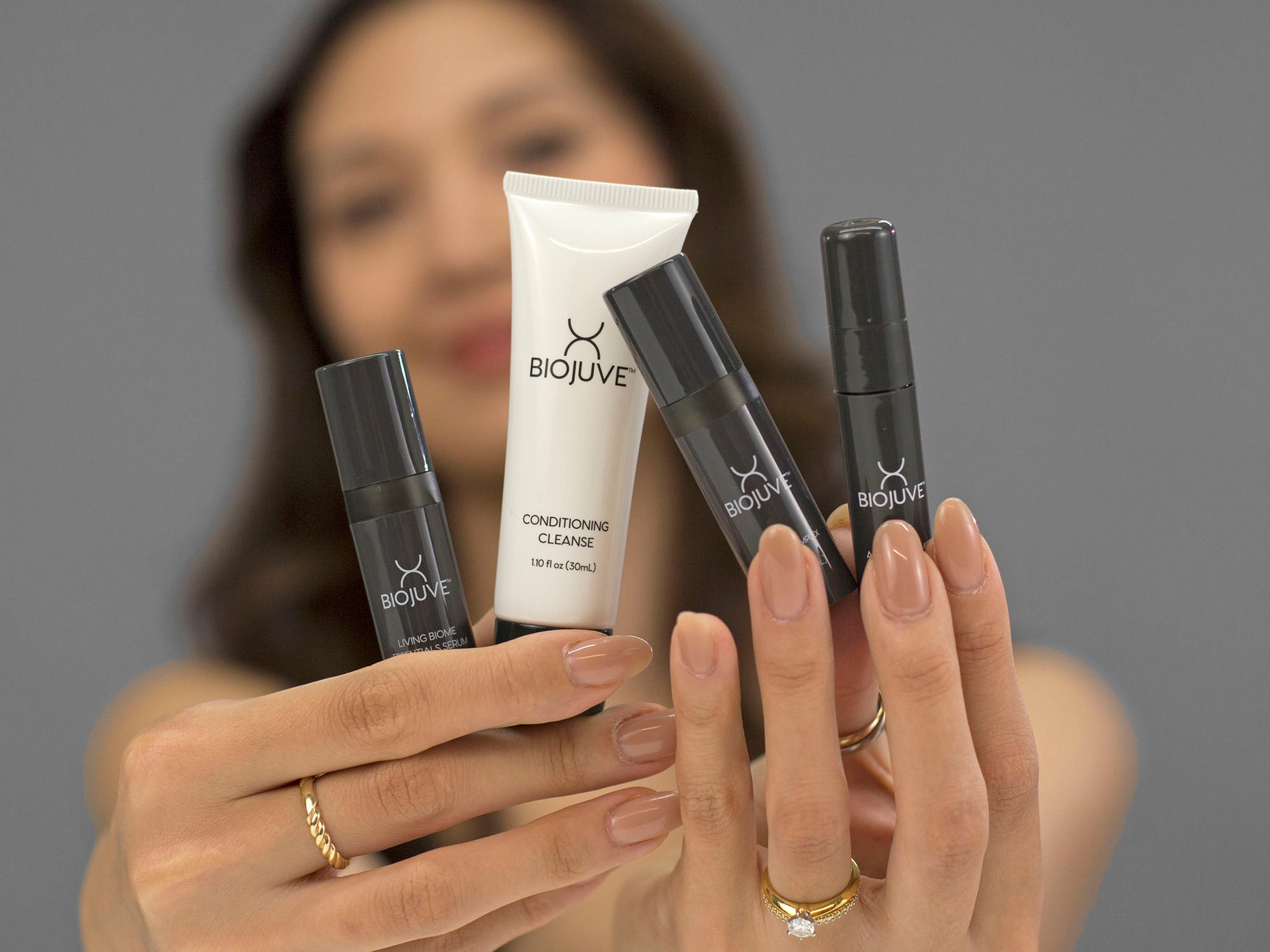 Laziza from LAZ Skincare showing the products included in the BioJuve Travel Kit with a blurred background