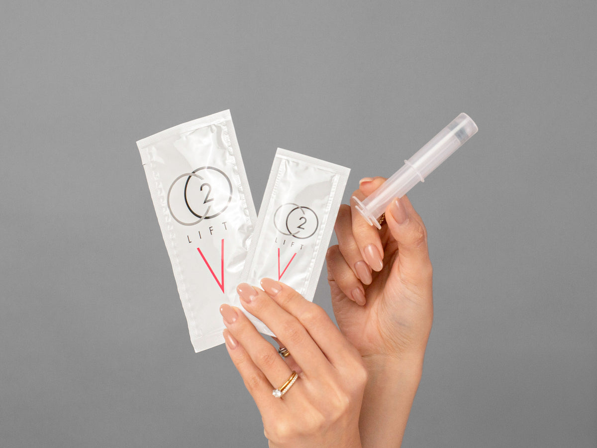 Closeup of Laziza from LAZ Skincare holding up a bottle of Lumisque CO2Lift V Vaginal Treatment