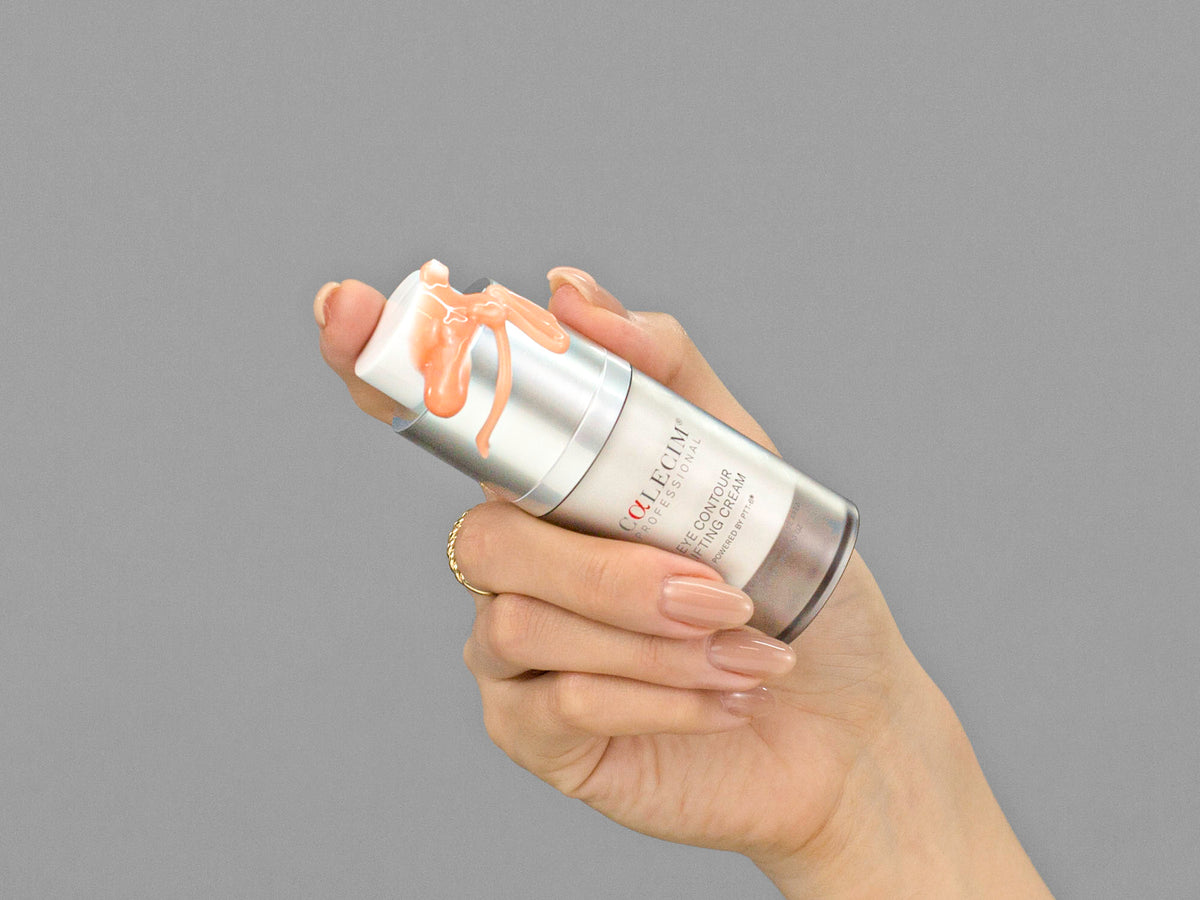 Closeup of Laziza from LAZ Skincare holding up a bottle of Calecim Eye Contour Lifting Cream