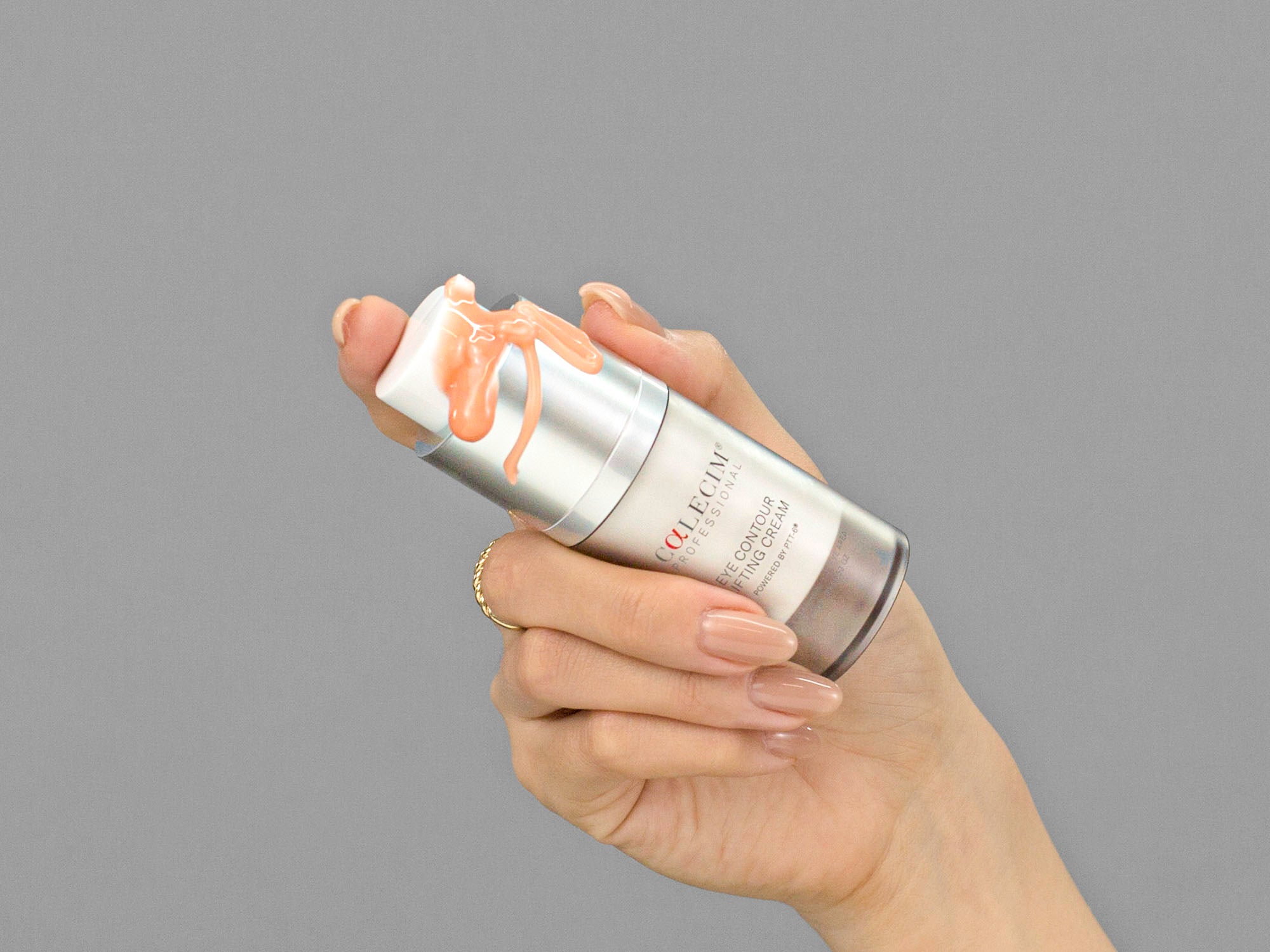 Closeup of Laziza from LAZ Skincare holding a bottle of Calcium Eye Contour Lifting Cream in her hand