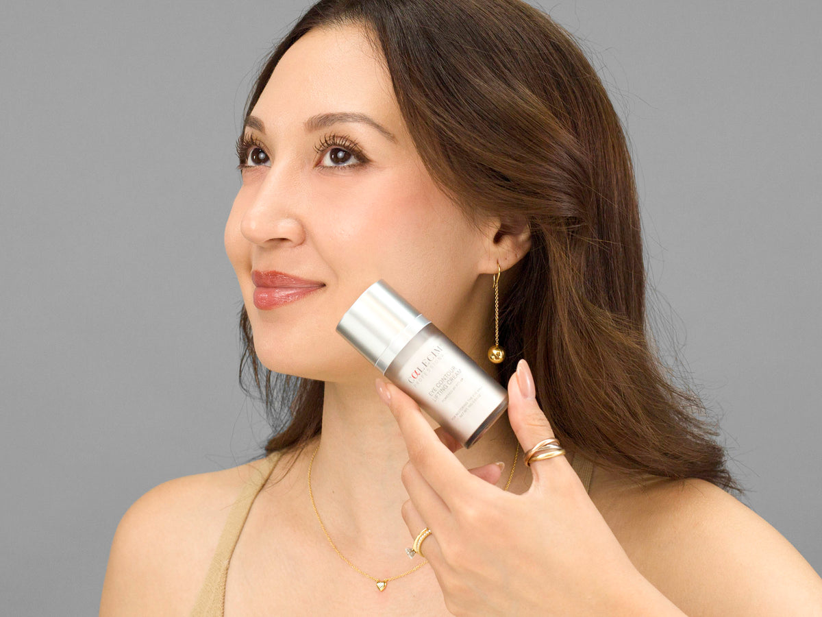 Laziza from LAZ Skincare holding a bottle of Calecim Eye Contour Lifting Cream up to her face