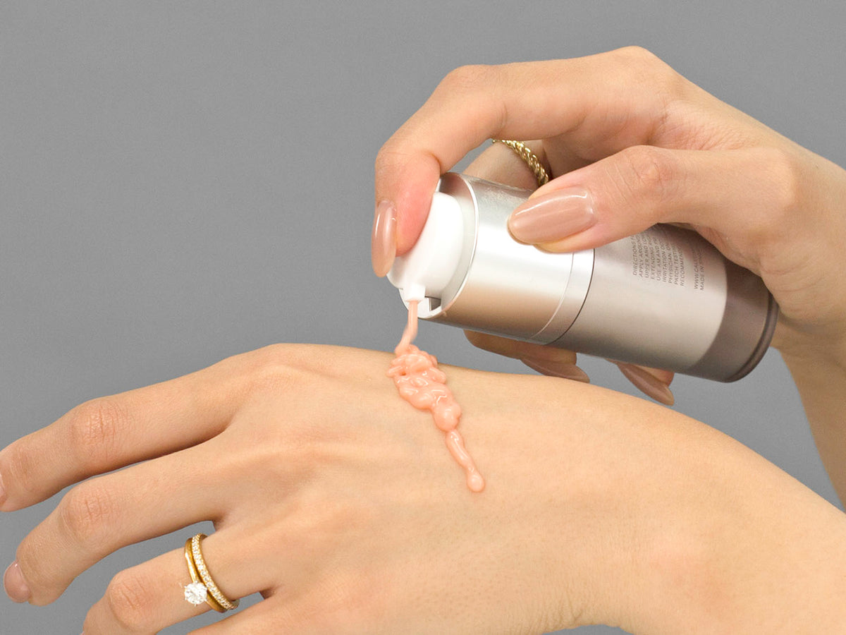 Laziza from LAZ Skincare demonstrating the texture and application of Calecim Eye Contour Lifting Cream on her hand