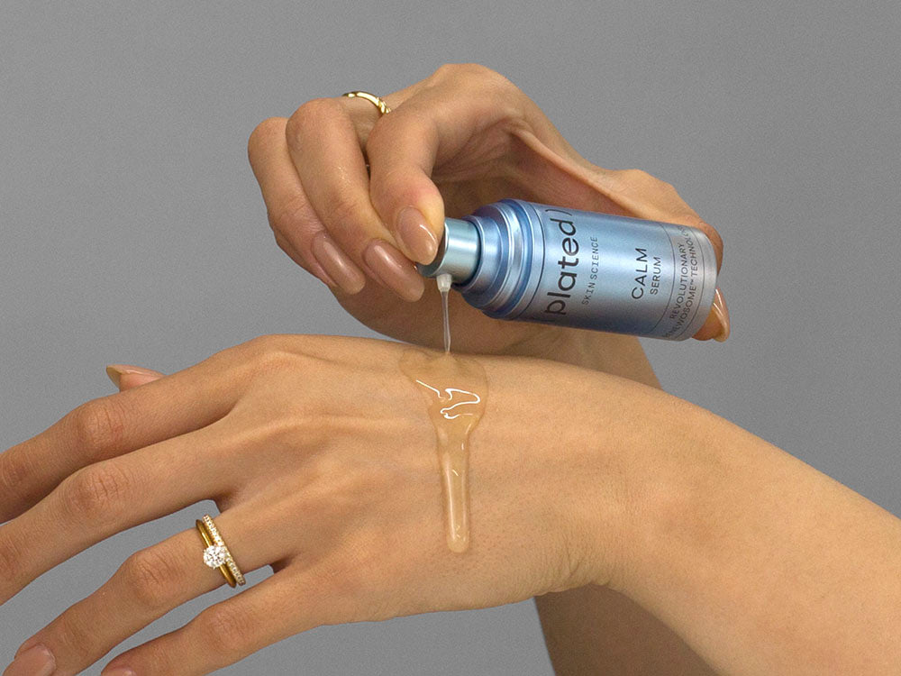 Laziza from LAZ Skincare demonstrating the texture and application of Plated Calm Serum on her hand