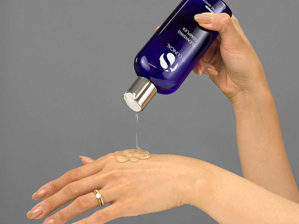 Laziza from LAZ Skincare demonstrating the texture and application of iS Clinical Cleansing Complex on her hand