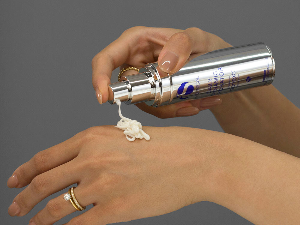 Laziza from LAZ Skincare demonstrating the texture and application of iS Clinical Daily Dynamic Hydrator on her hand