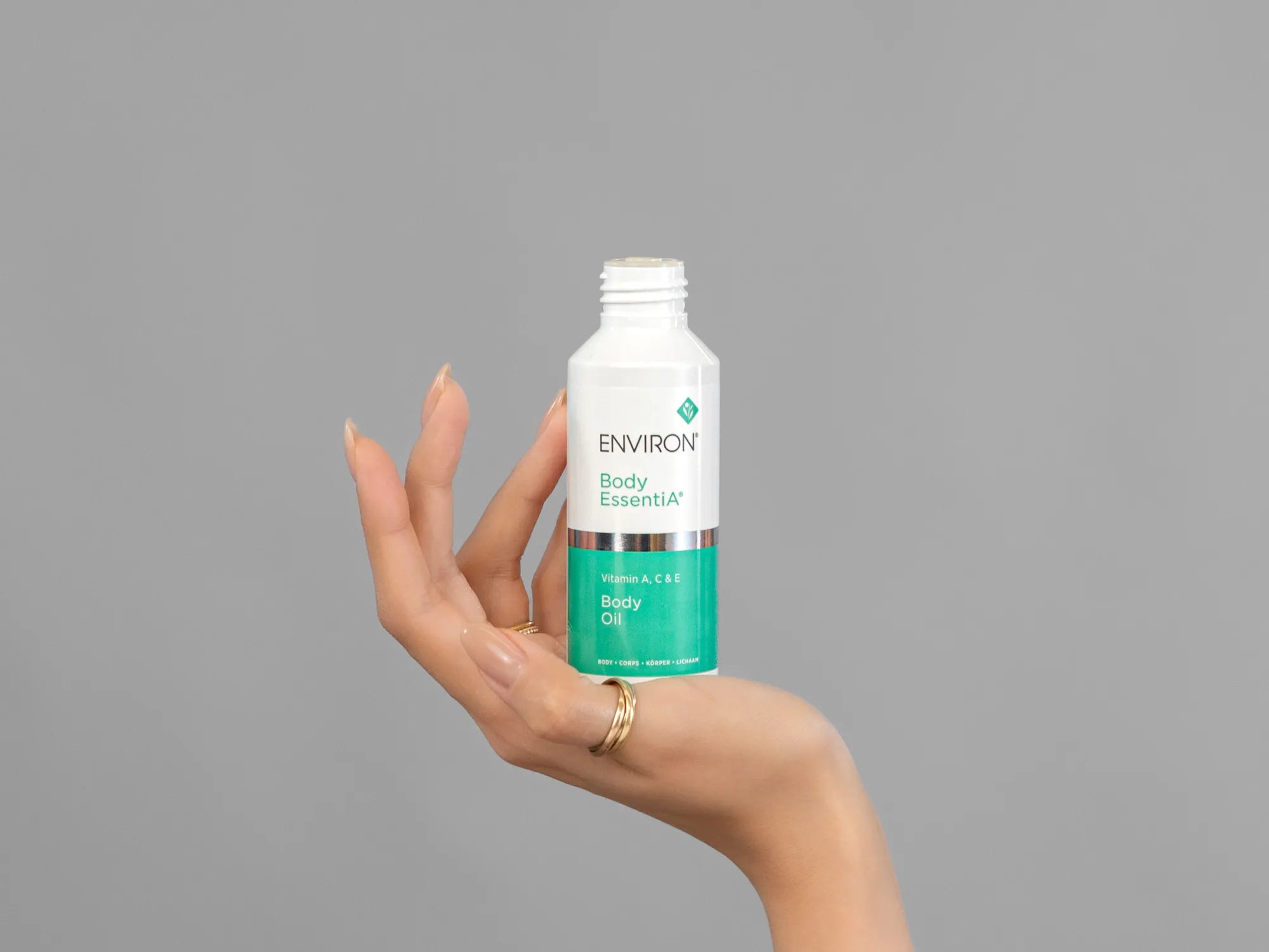 Closeup of Laziza from LAZ Skincare holding up a bottle of Environ Body Oil