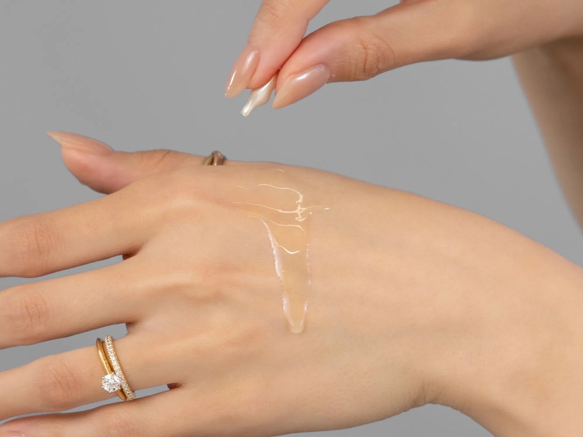 Laziza from LAZ Skincare demonstrating the texture and application of Environ Hydrating Oil Capsules on her hand