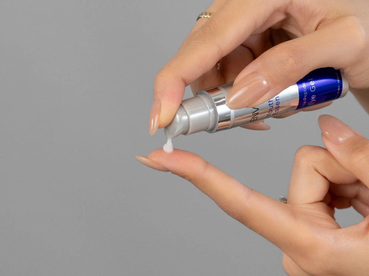 Closeup of Laziza from LAZ Skincare holding up a bottle of Environ Vita-Peptide Eye Gel