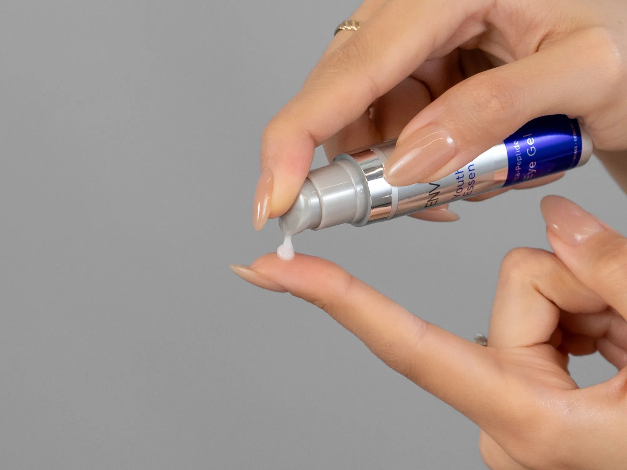 Closeup of Laziza from LAZ Skincare holding up a bottle of Environ Vita-Peptide Eye Gel