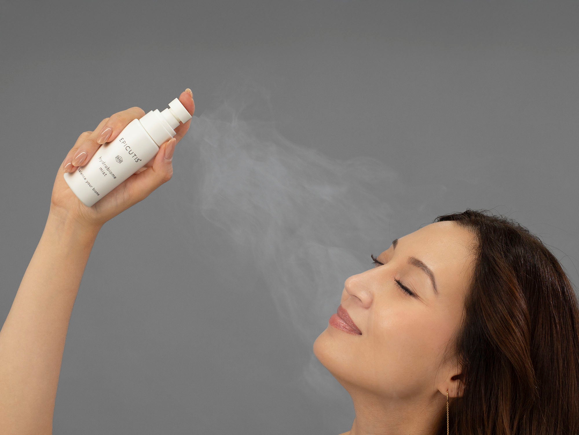 Laziza from LAZ Skincare spraying her face with Epicutis Hydrobiome Mist