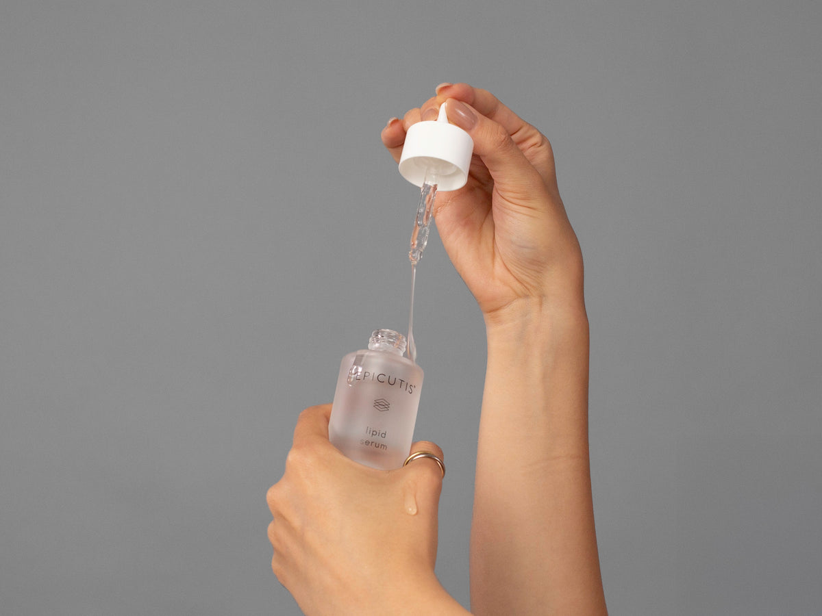 Closeup of Laziza from LAZ Skincare holding up a bottle of Epicutis Lipid Serum