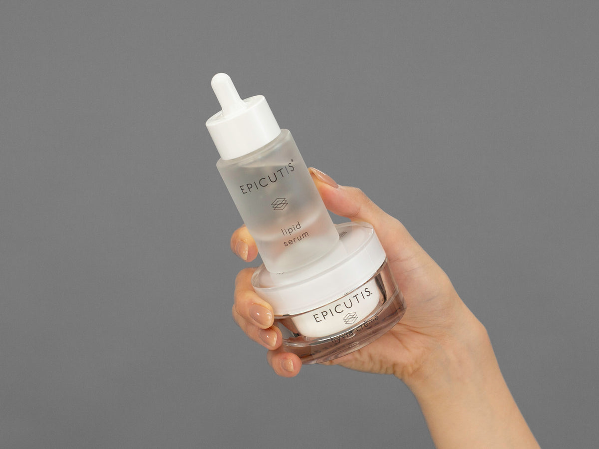 Closeup of Laziza from LAZ Skincare holding up a bottle of Epicutis Luxury Skincare Set