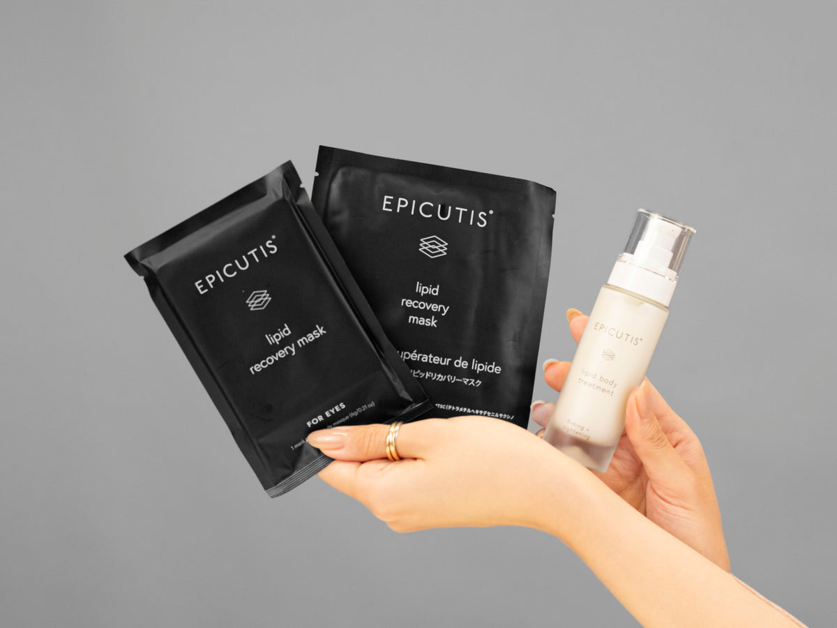 Closeup of Laziza from LAZ Skincare holding up a bottle of Epicutis Luxury Travel Set