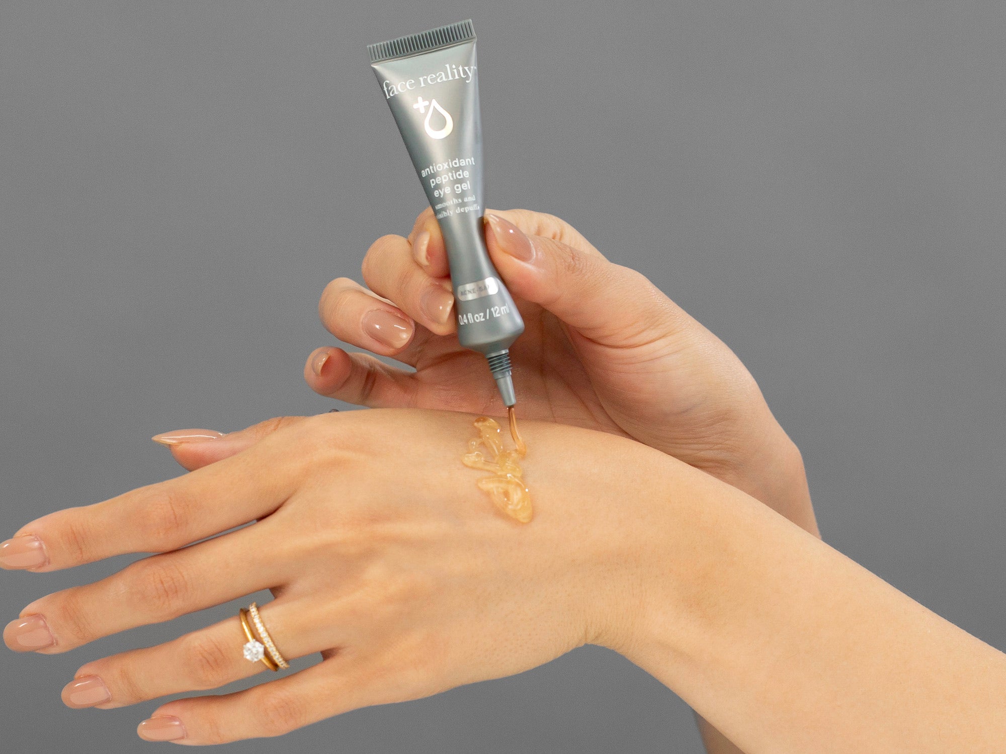 Closeup of Laziza from LAZ Skincare applying Face Reality Antioxidant Peptide Eye Gel to her hand