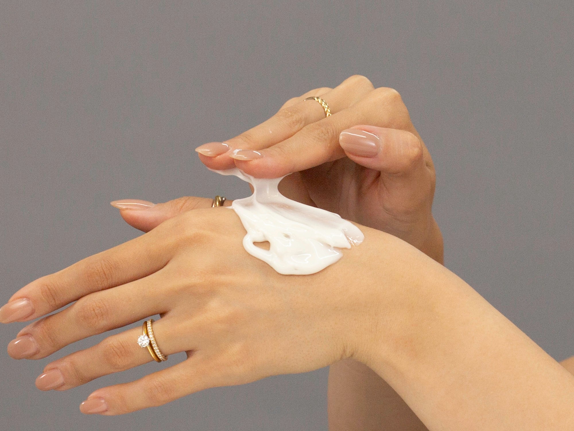 Closeup of Laziza from LAZ Skincare applying Face Reality Brighten-C Mask to her hand