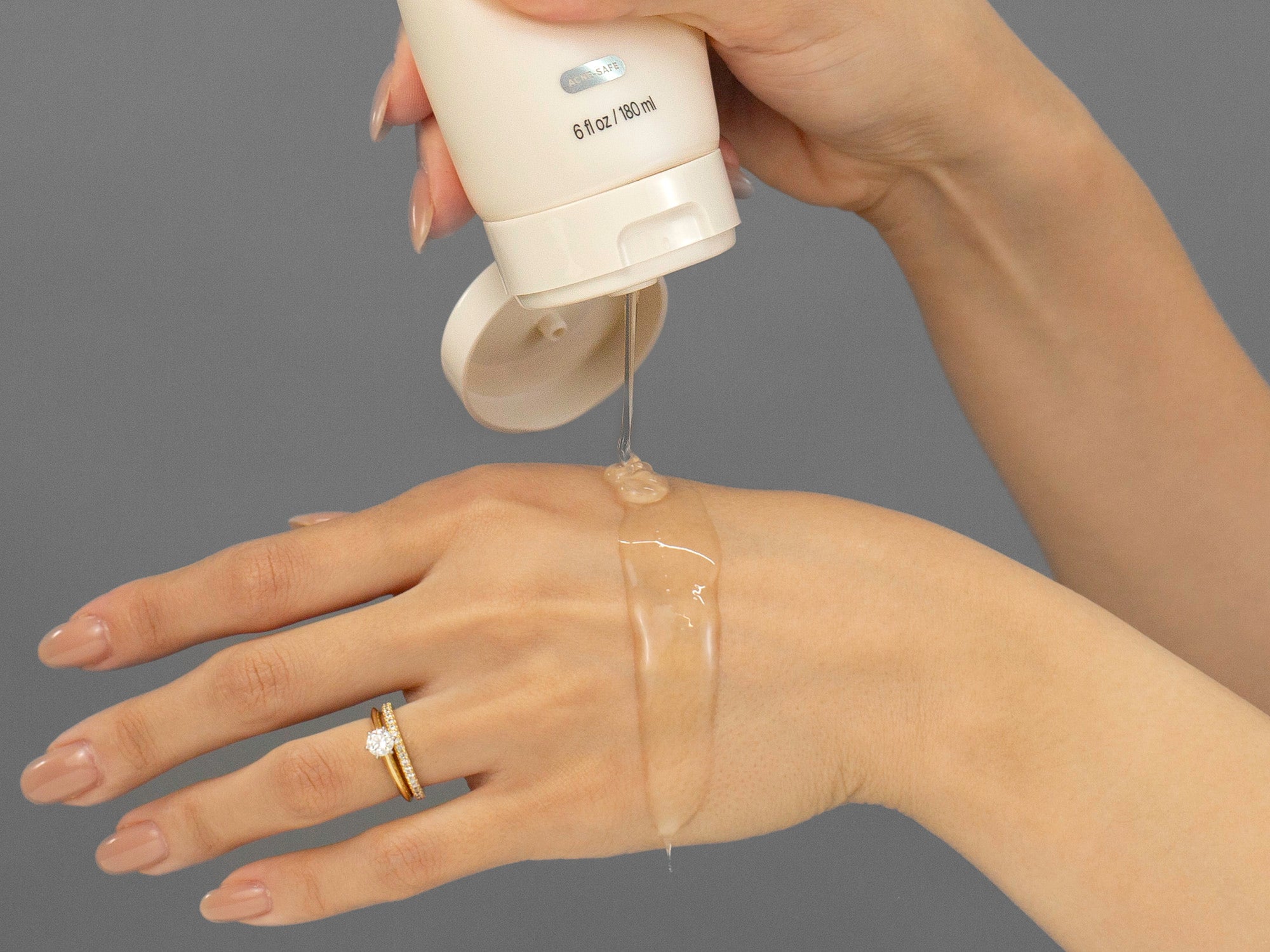 Closeup of Laziza from LAZ Skincare applying Face Reality Mandelic Face & Body Wash to her hand