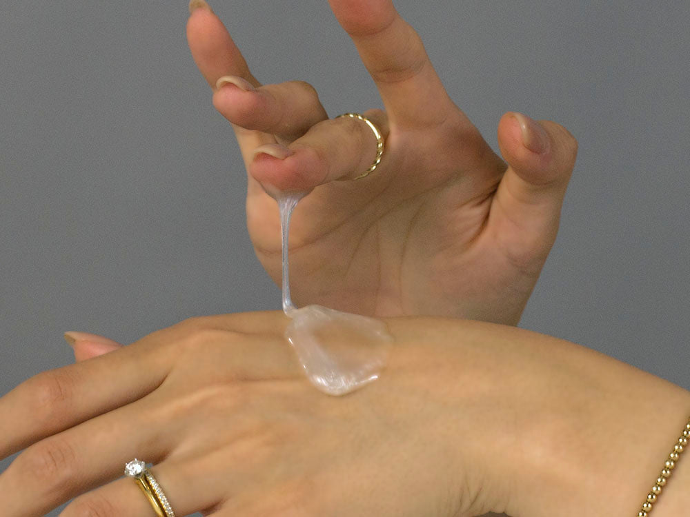 Laziza from LAZ Skincare demonstrating the texture and application of Alastin Gentle Cleanser on her hand