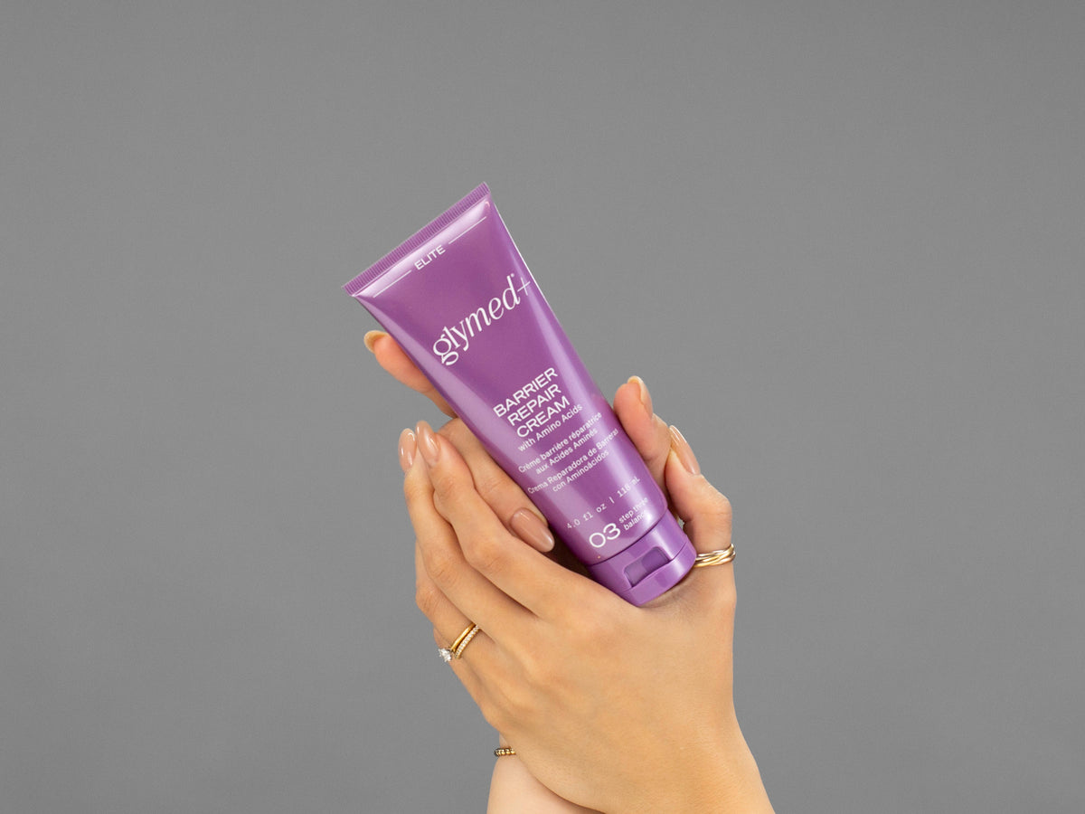Closeup of Laziza from LAZ Skincare holding up a bottle of GlyMed Barrier Repair Cream
